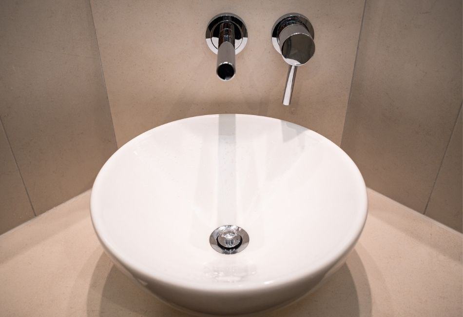 Round vessel sink with wall mounted faucet