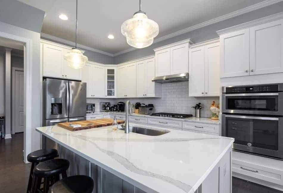 white marble kitchen countertop with single stainless steel faucet