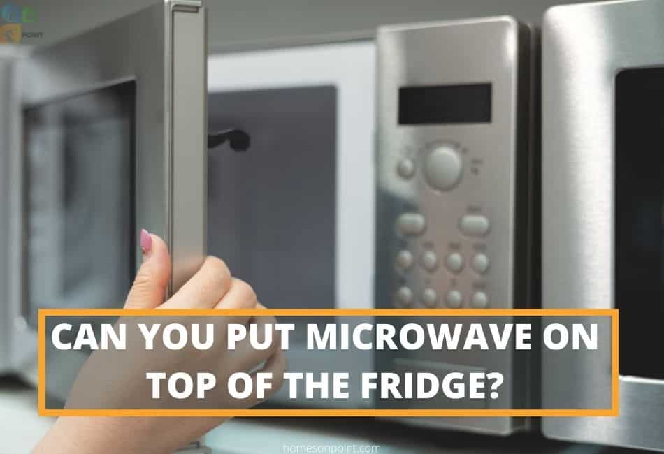 Woman opening microwave on top of the fridge