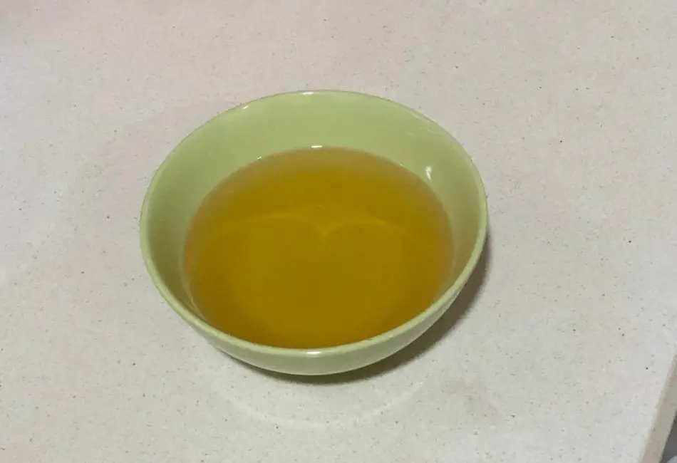 Cooking oil in a green ceramic bowl