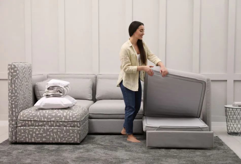 woman making convertible sofa to bed