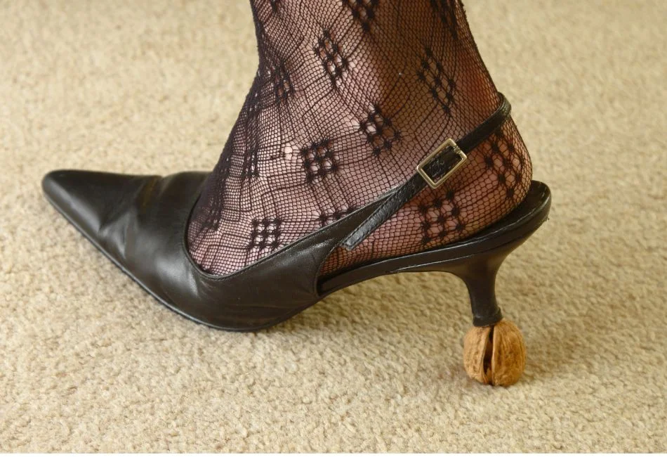woman with heels walking on carpet